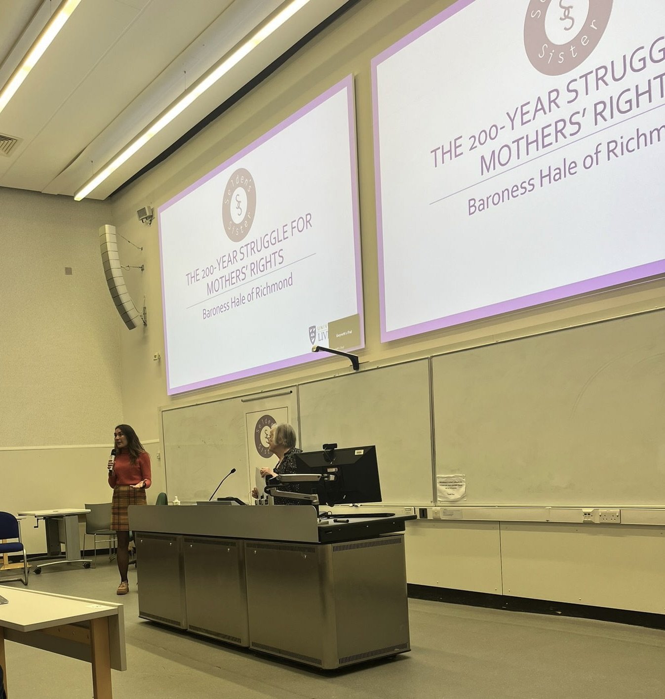 A photograph of Lady Brenda Hale speaking on Mothers' Rights at the University of Liverpool in 2024, with Selden's Sister co-founder Dr Emily Ireland.