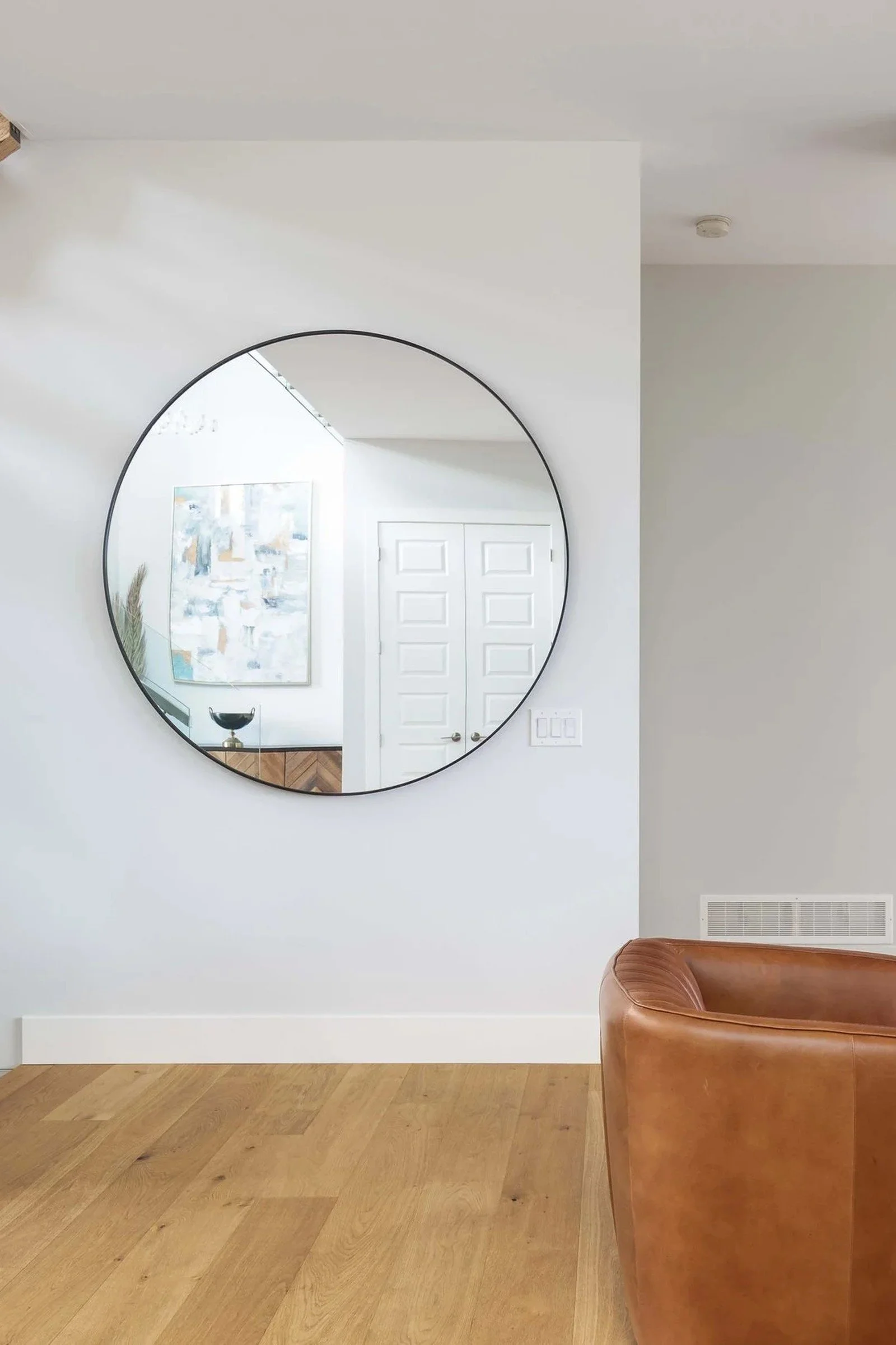 Bright living room with round mirror