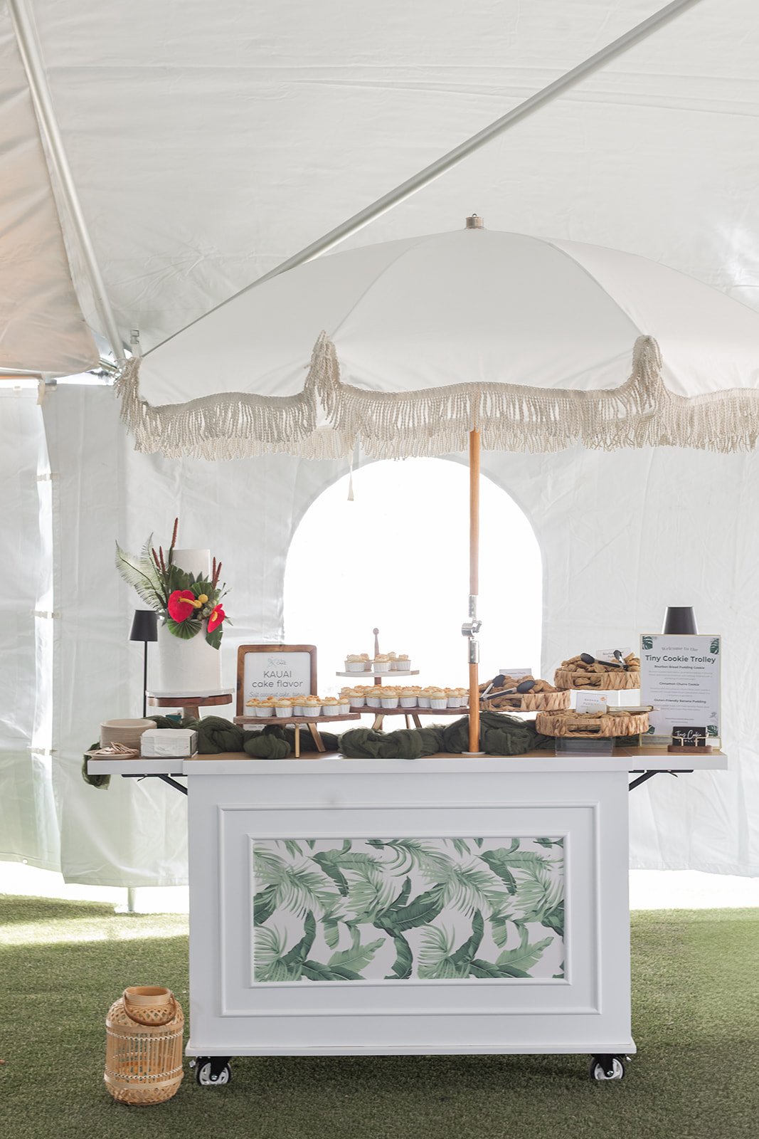 Cute wheeled cart with filled with treats and styled with a tropical look