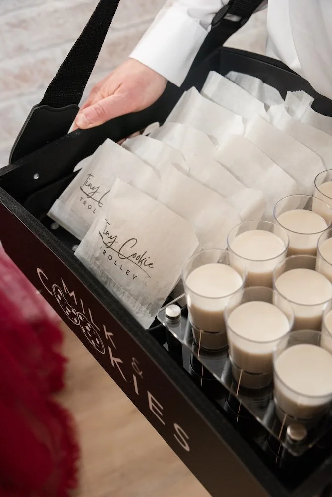 close up of an usherette tray with cookie bags and milk shots