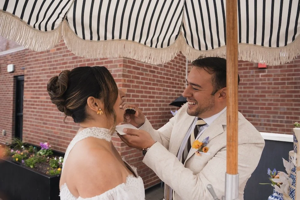 Bride and groom feeding each other a brownie