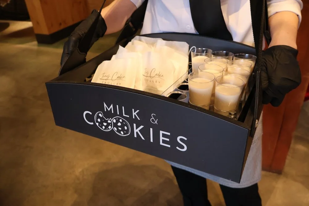 Close up of a tray with cookie bags and shots of milk