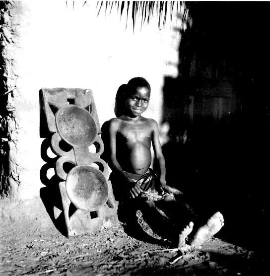 Boy next to food bowl. Abiriba Igbo. — G. I. Jones