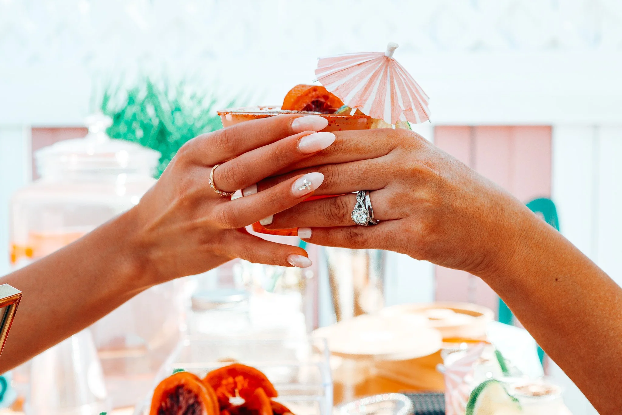White fringed patio umbrella viewed from below against a light background.