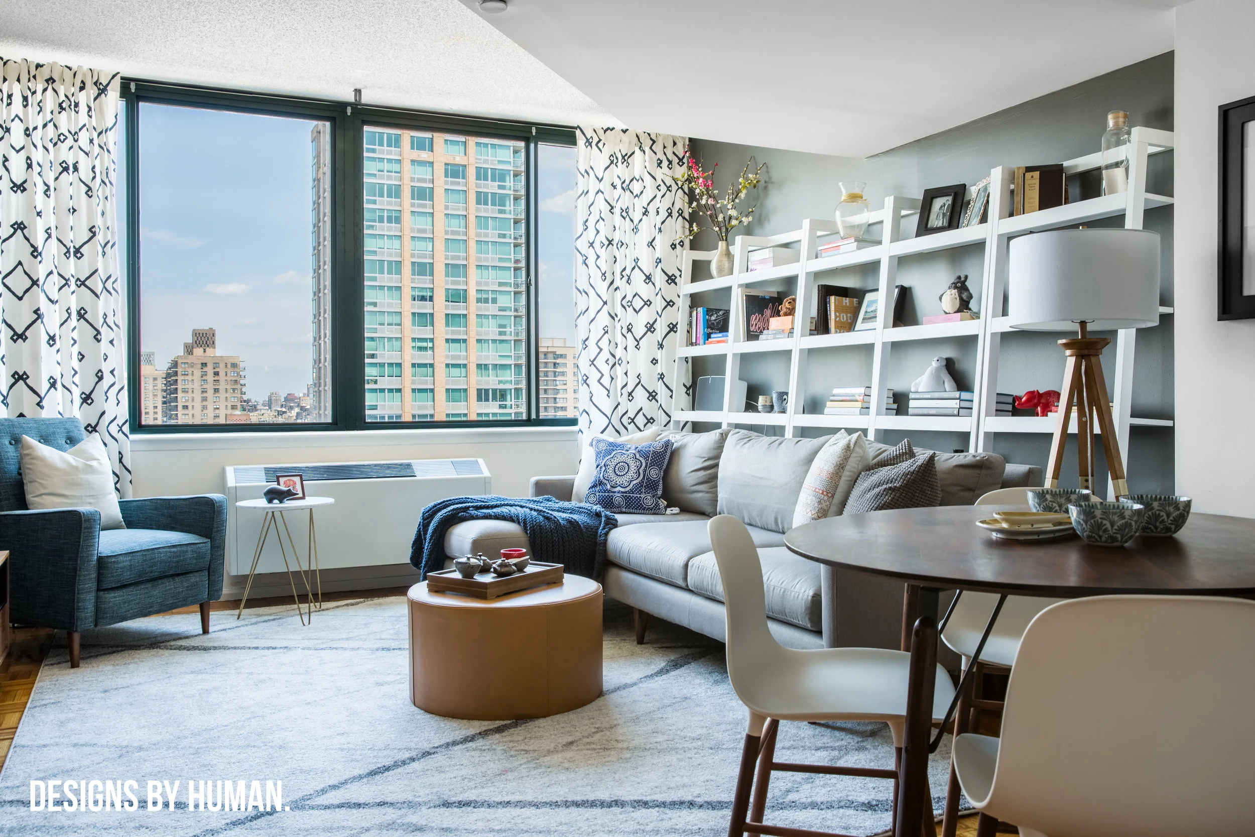 Living Room - Feng Apartment by Designs By Human. We used dark gray accent walls to help to add depth to the space.