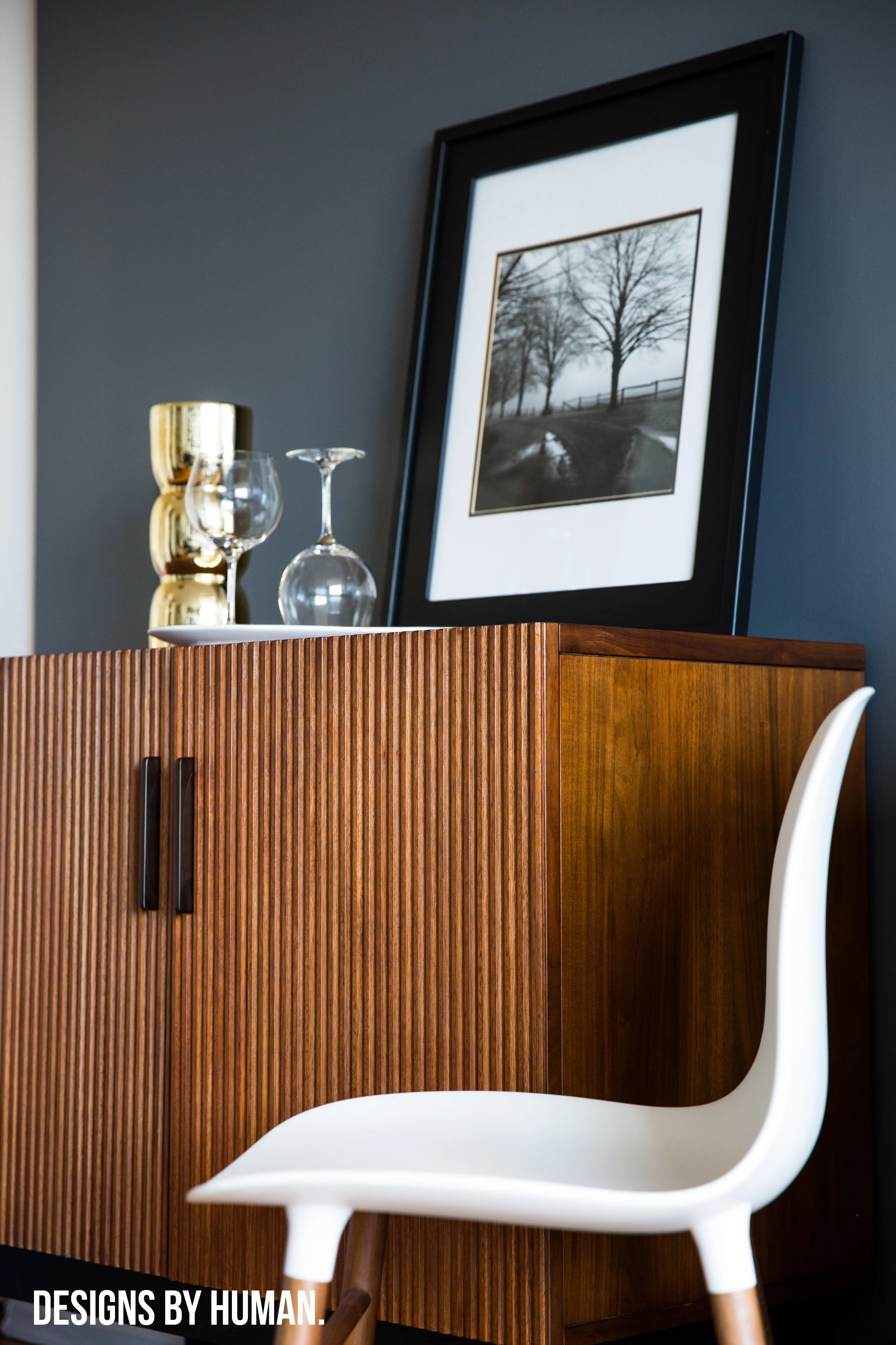Bar Area - Feng Apartment by Designs By Human. The dark grey walls actually helped to brighten the space and make it feel larger.