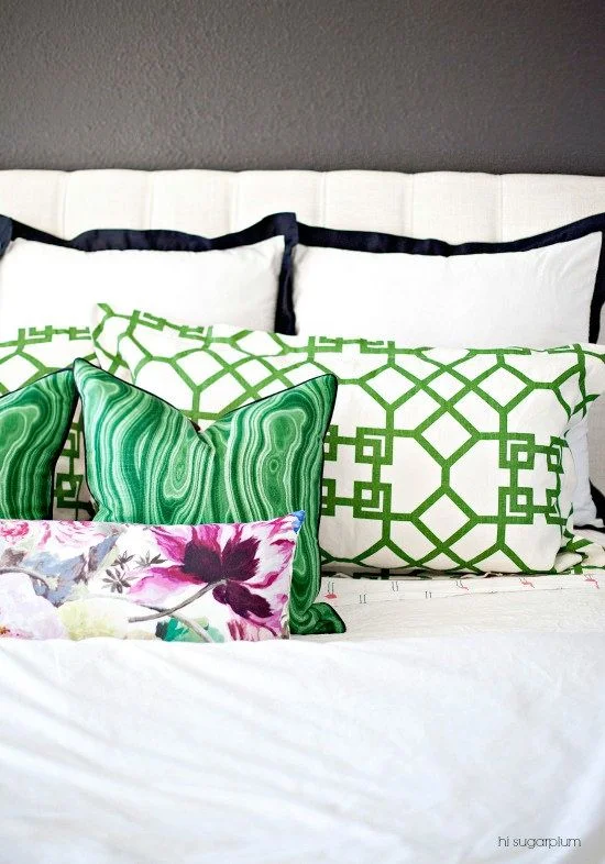 You can incorporate Greenery in a subtle way by using accent pillows. We like this example from Hi Sugarplum.