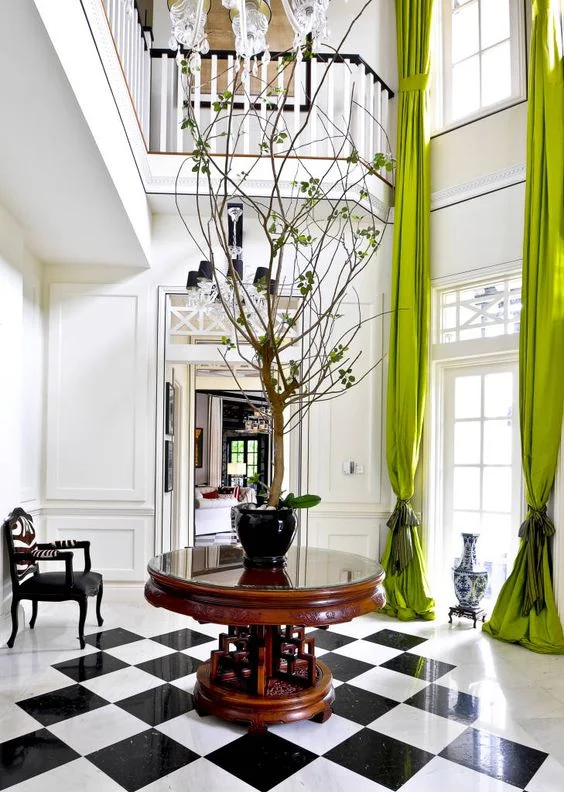 This luxe black and white interior space is brought to life with the addition of green drapery. Image source: Interiors By Studio M.