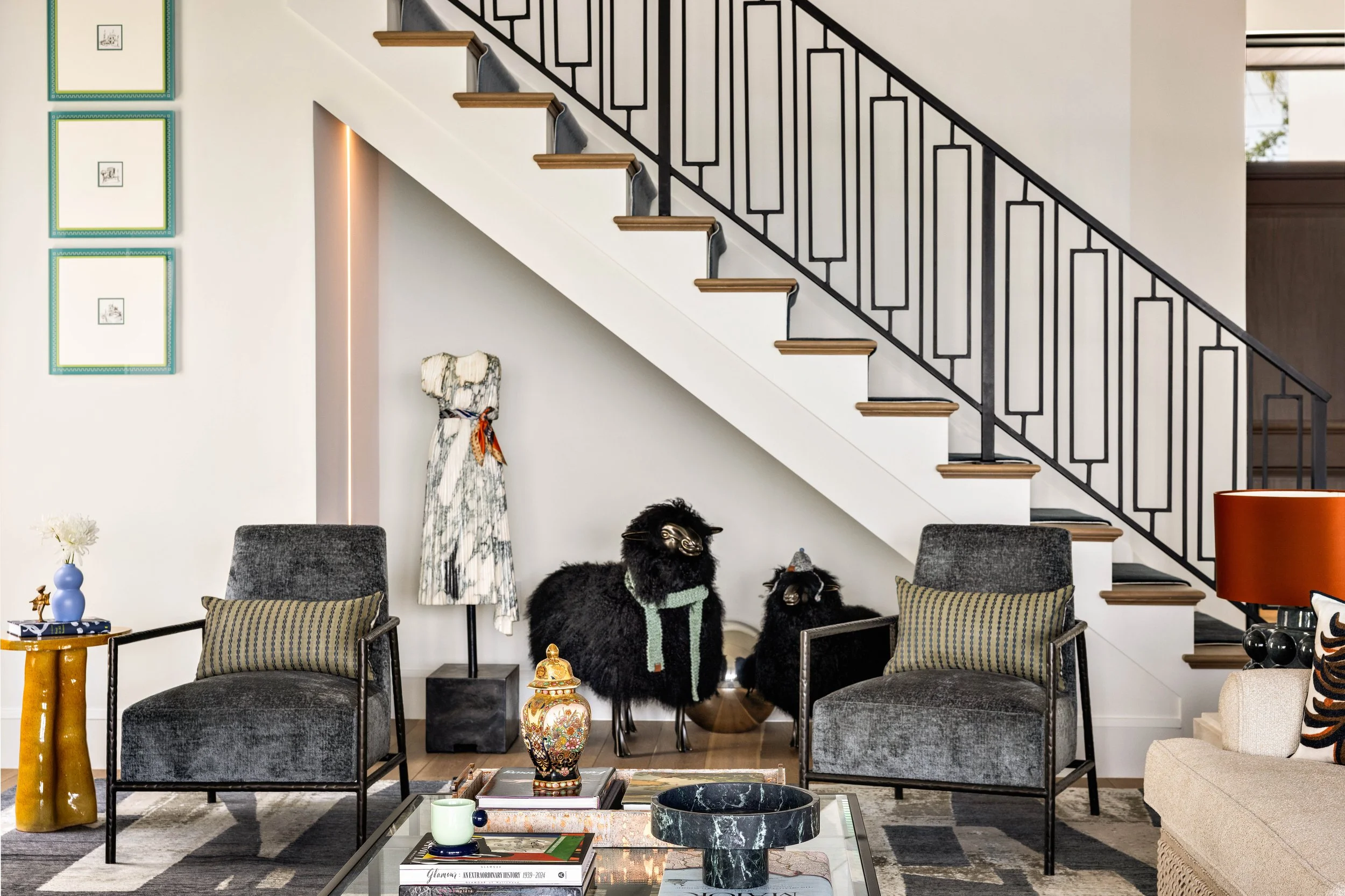 Artful living room with a staircaise and custom runner as well as furniture.