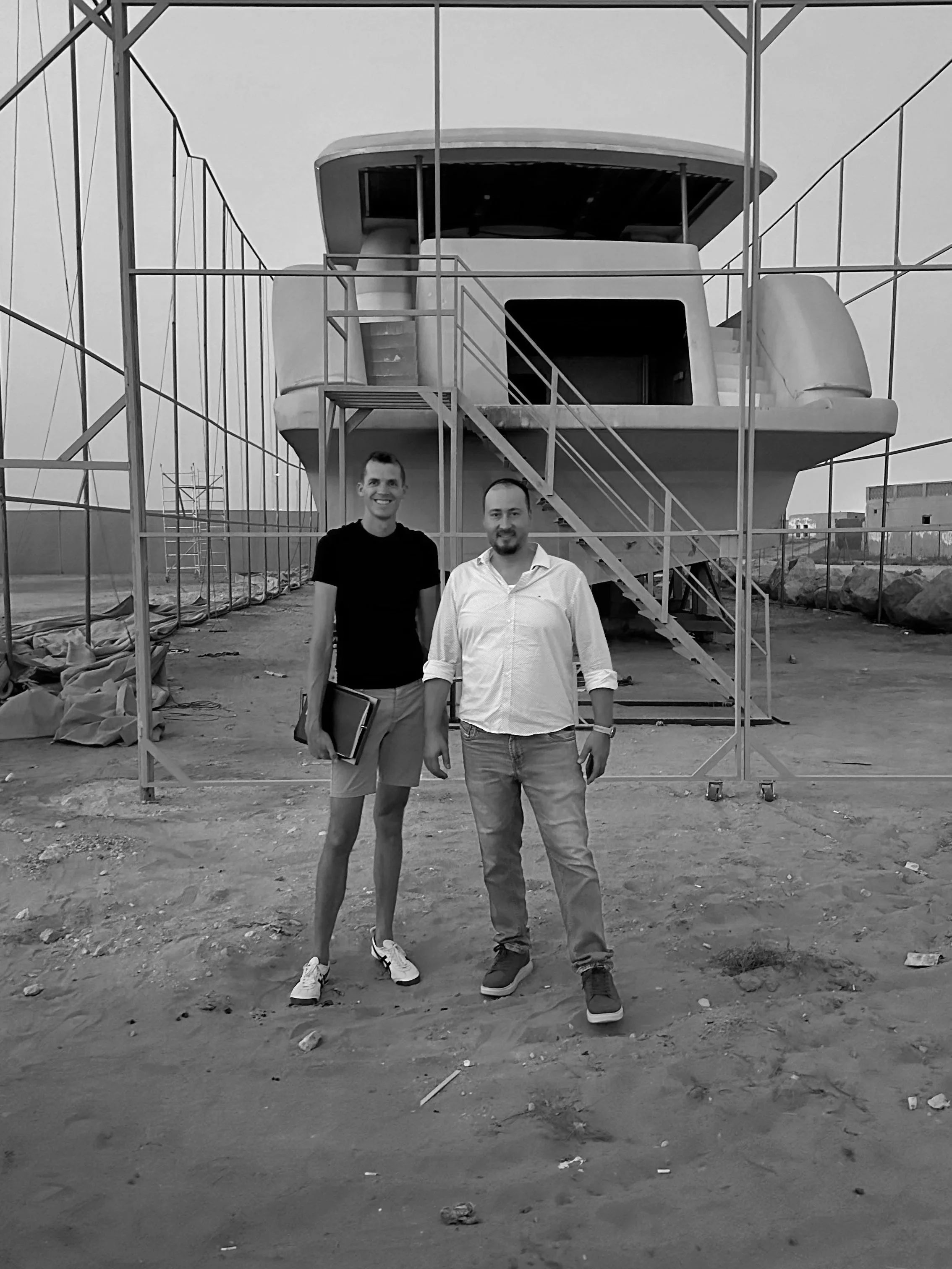 Superyacht in the background as a photo with our client before we start working on their project.
