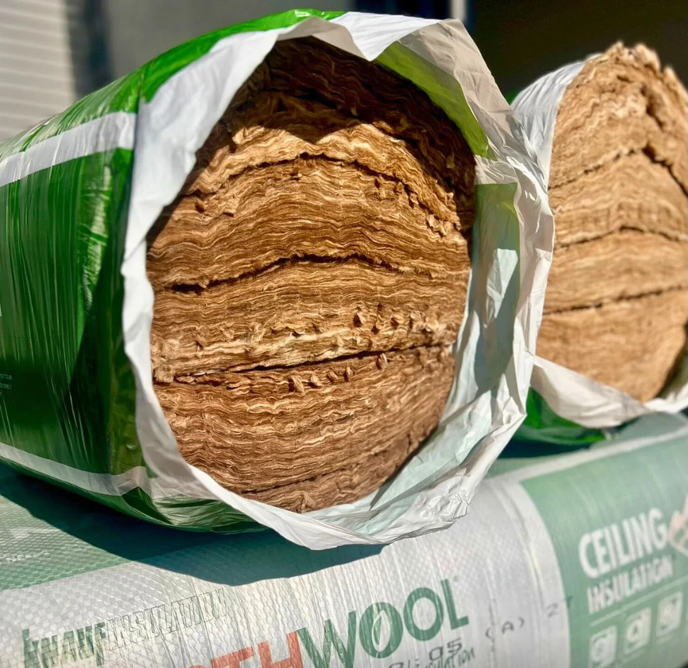 A bail of natural earthwool insulation material is stacked on top of more bails.