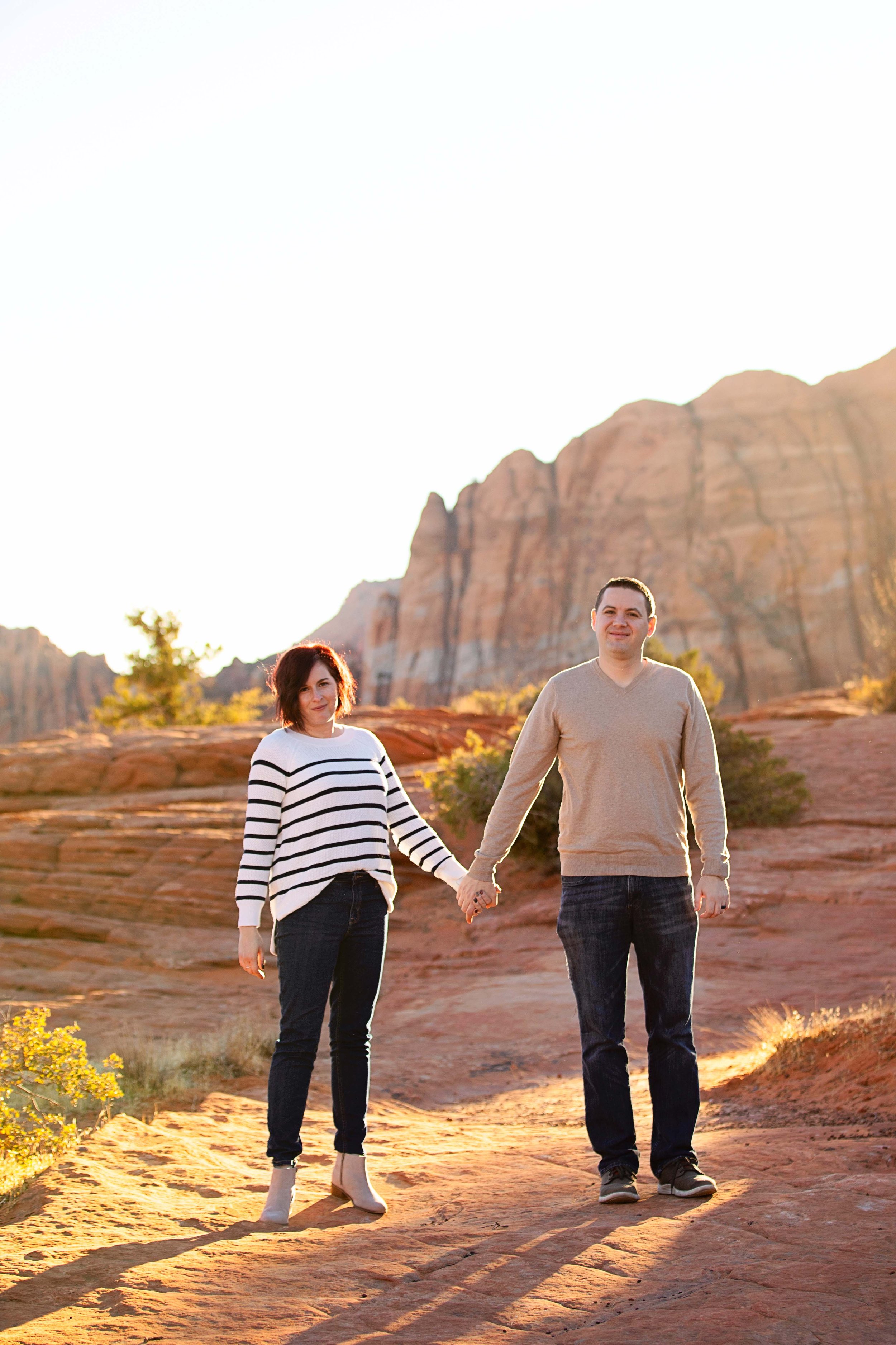 Mom-and-dad-holding-hands-during-family-session-in-Snow-Canyon,-UT