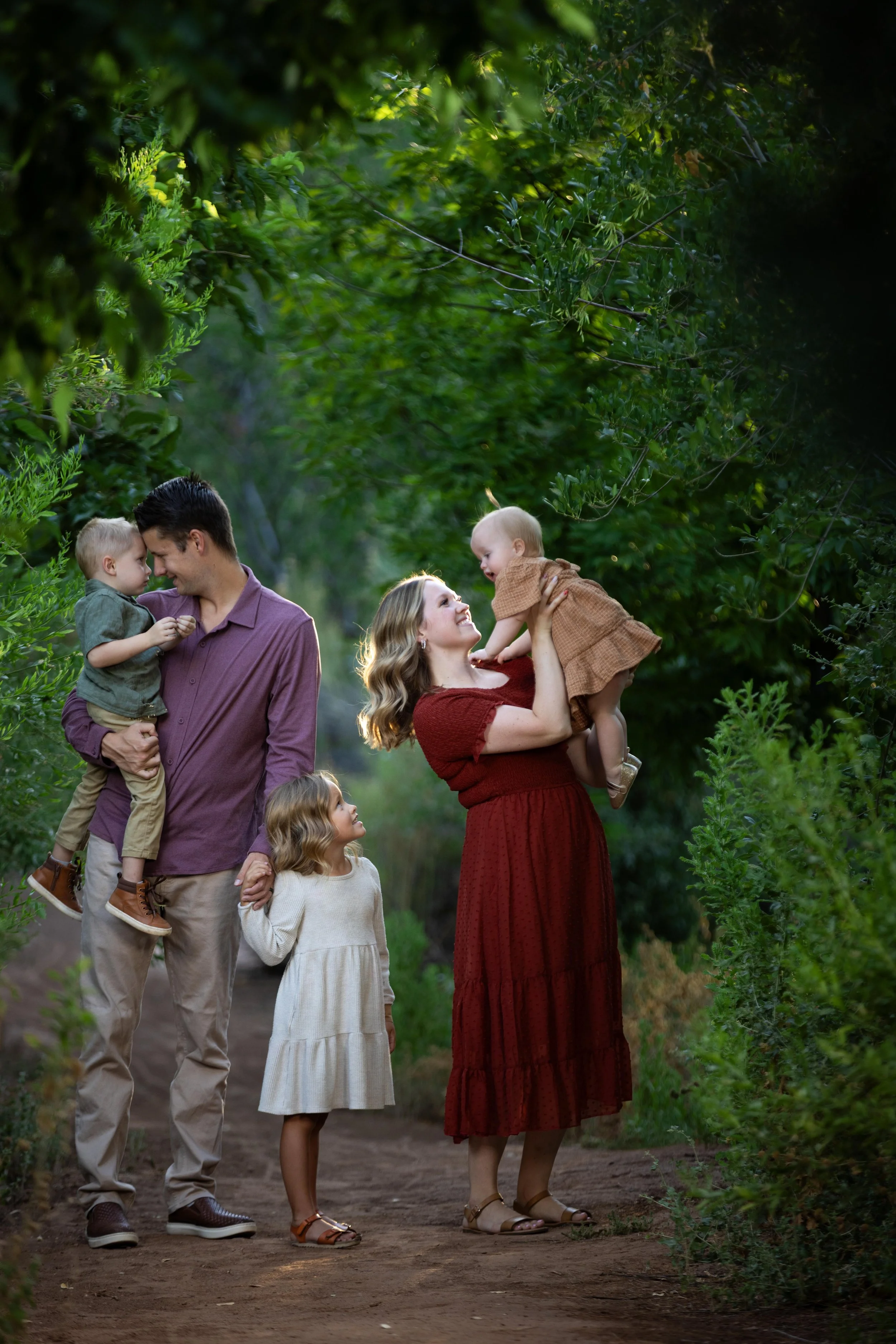 Family with small children play during their family portraits in Saint George Utah