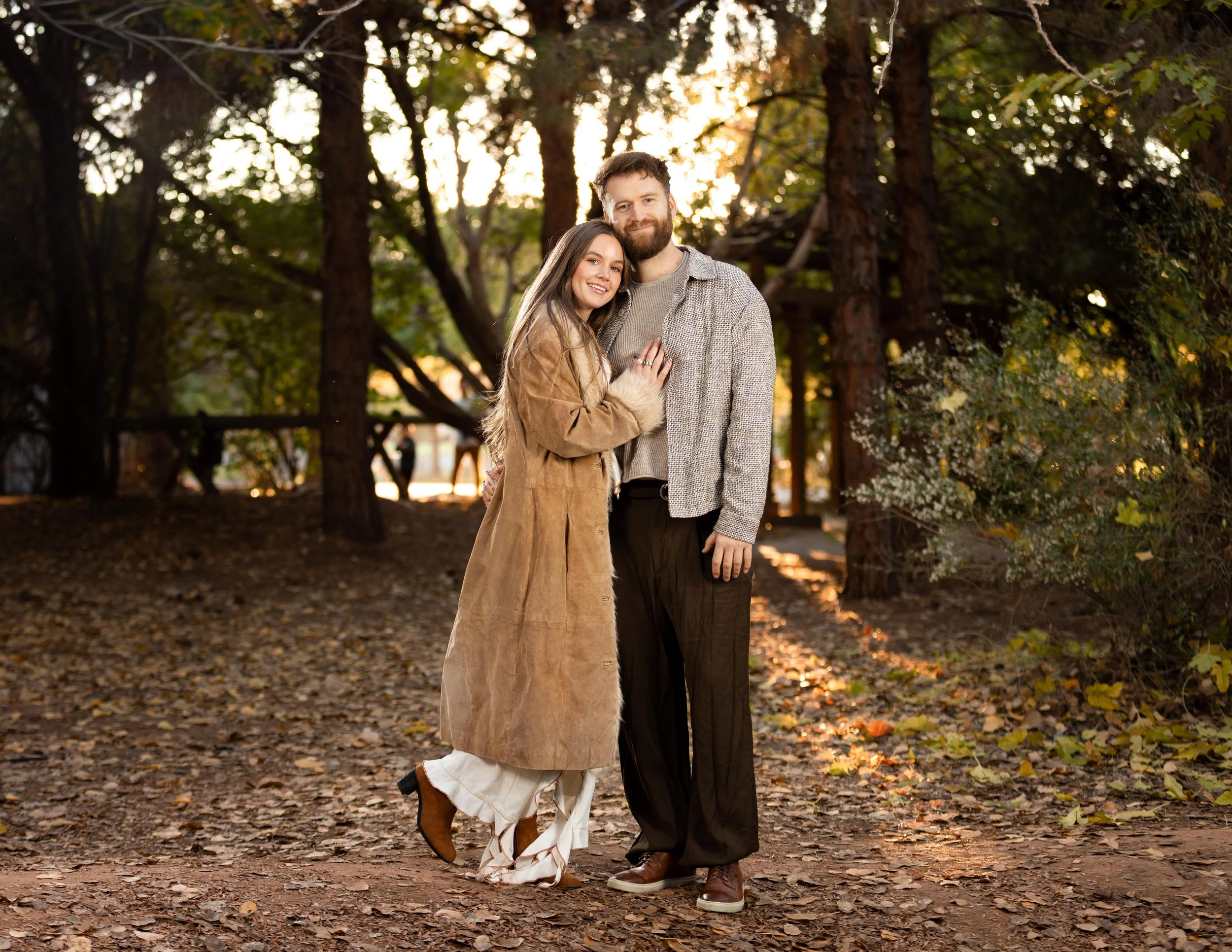 Man and women cuddle close looking at the camera during engagement session in st. George  UT.