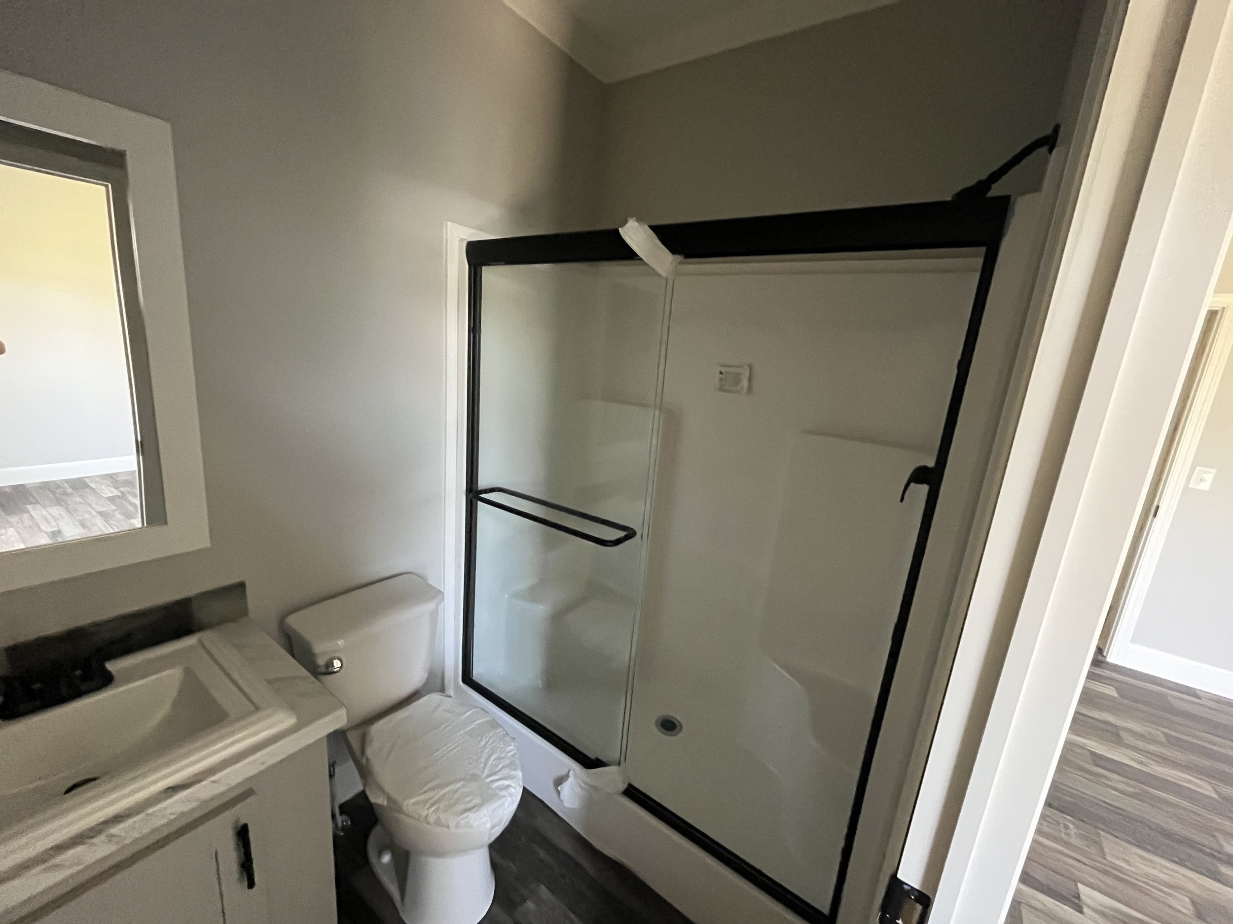Bathroom with shower stall, toilet, and sink