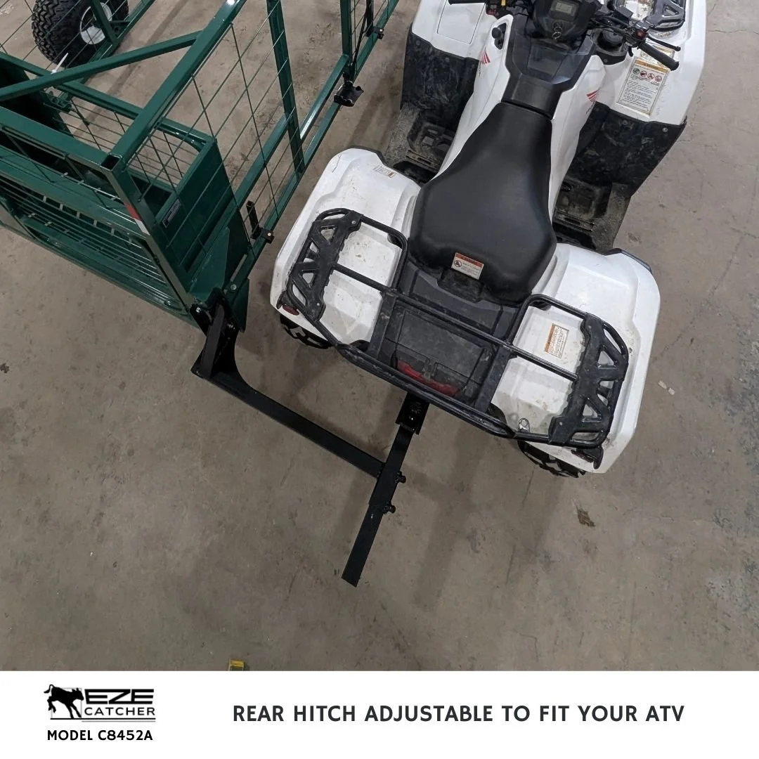A white ATV top view attached with a rear ball hitch to an Eze-Catcher Calf CAtcher