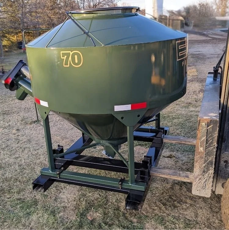 Bottom half view of an EZE Mini Bin sitting on green grass, showing the integrated fork pocket frame of the feed bin