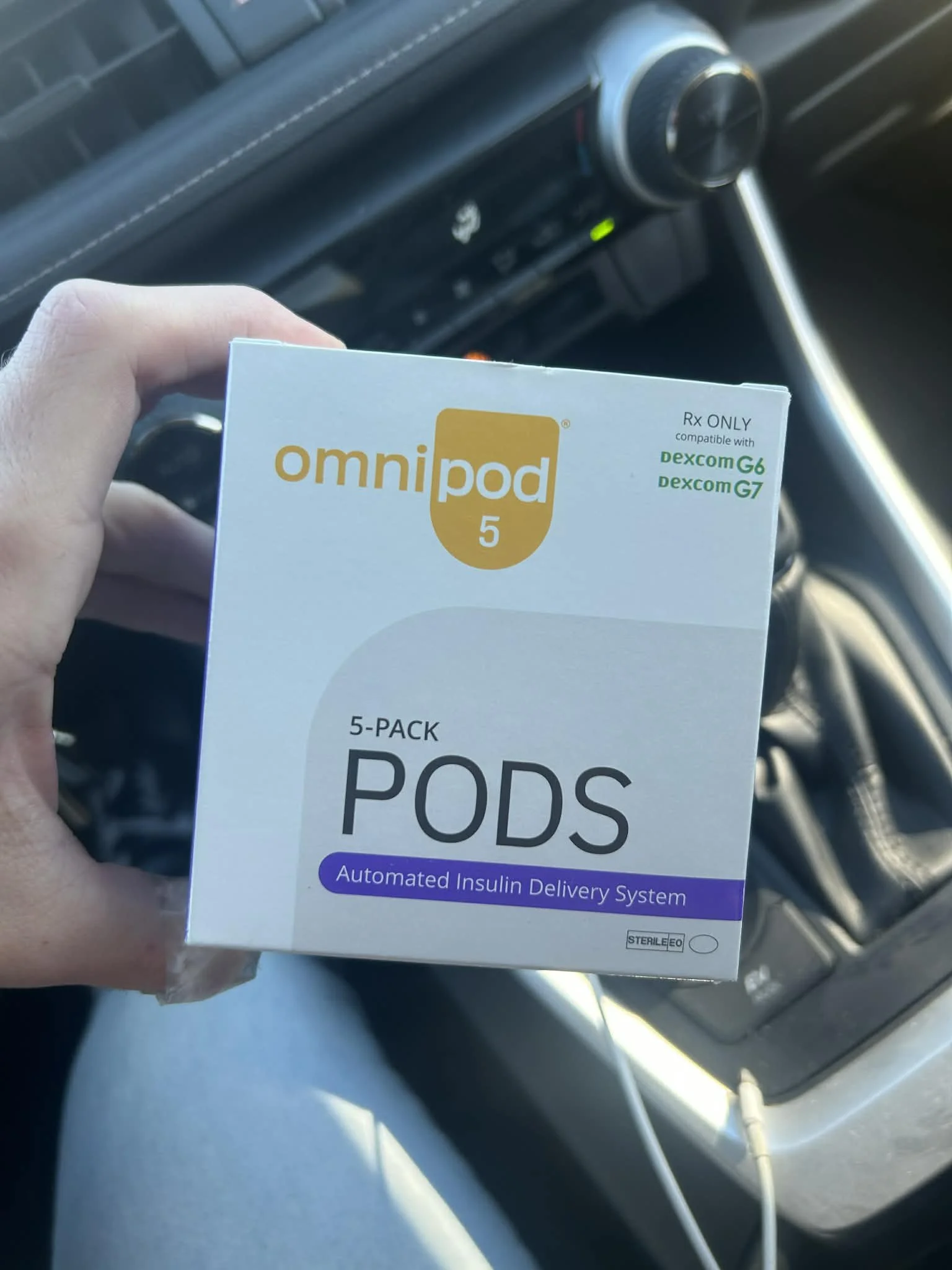 Unopened Omnipod 5 pods 5-pack box held in hand ready to sell for cash