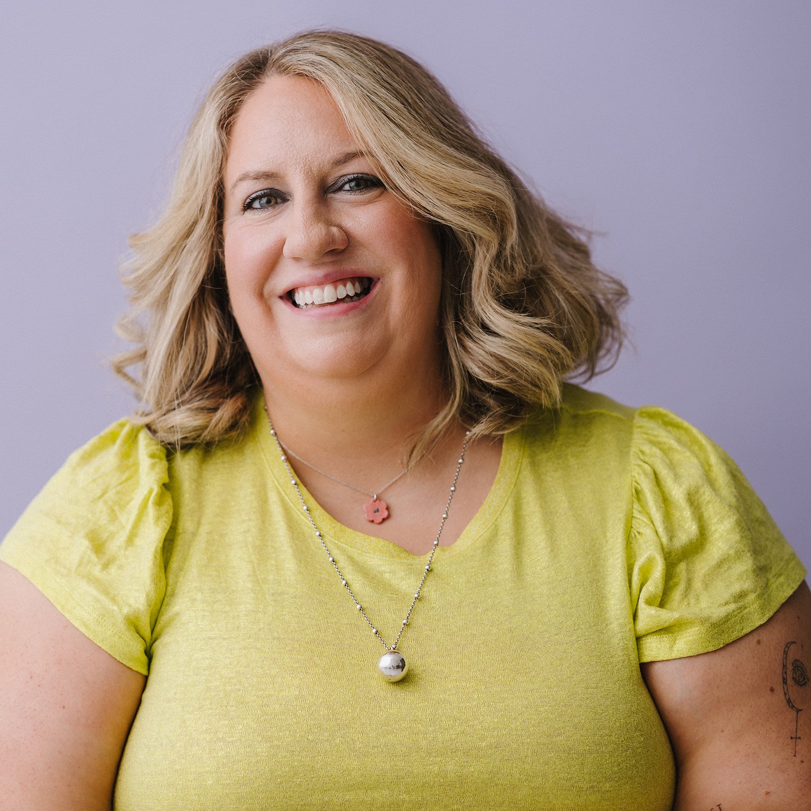 Headshot of paralympian Elle Steele smiling in a green shirt.