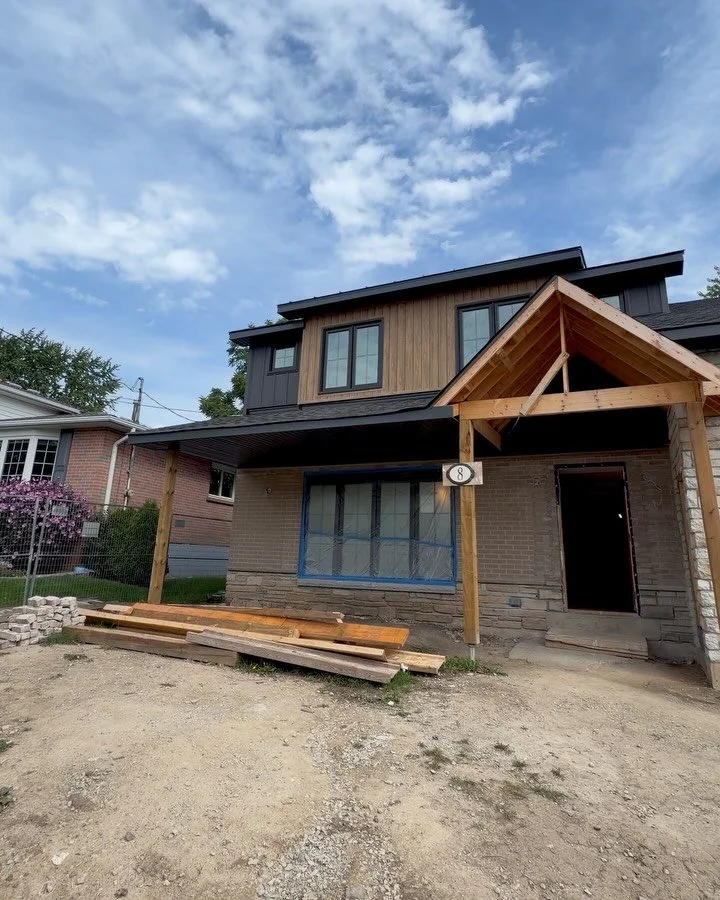 The Sherman Project exterior is taking shape.

Once a single-level home, the expanded footprint now includes a full second storey, a new garage, and a front porch designed to give the home a more welcoming sense of arrival.

Warm wood tones, dark sid