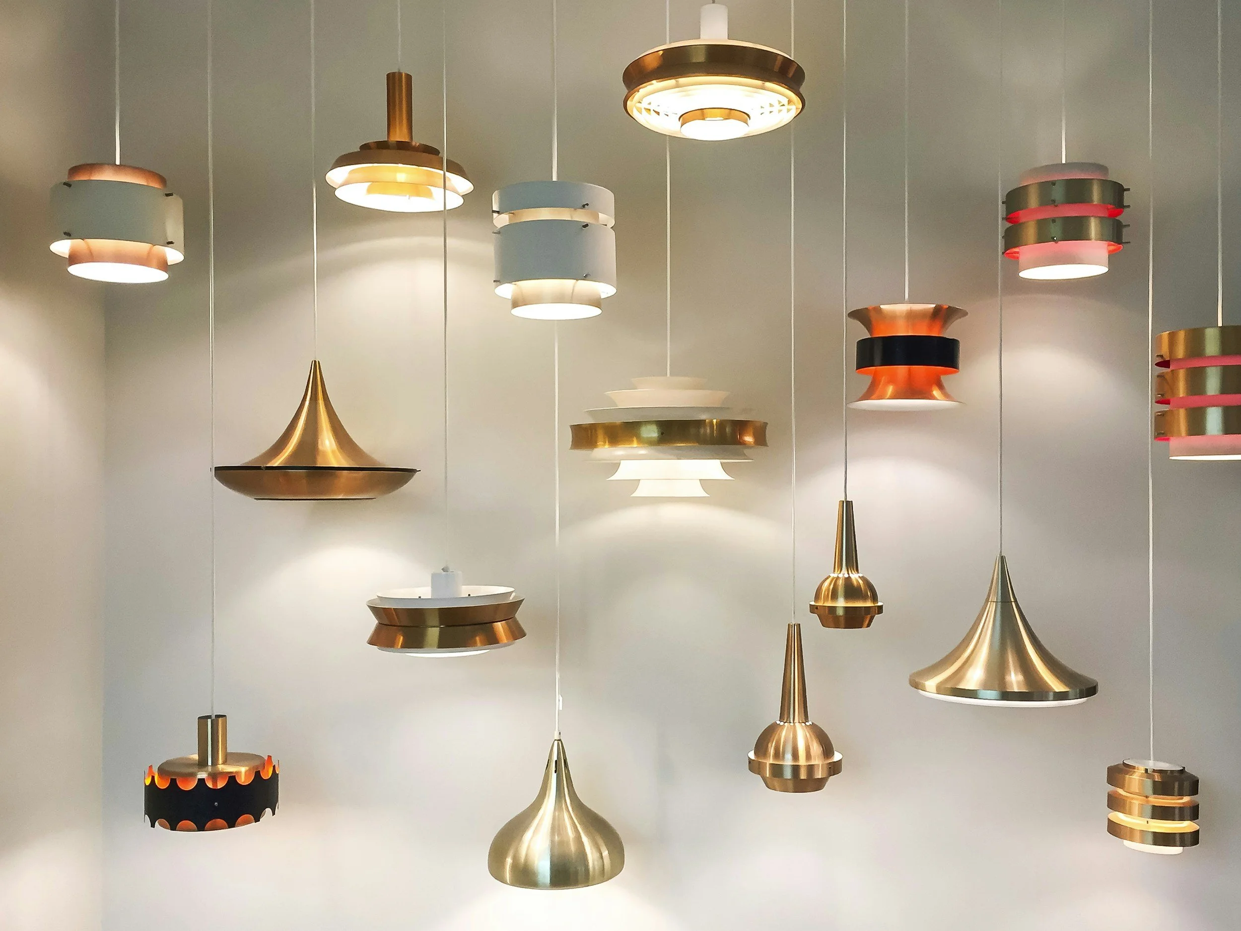 Modern ceiling light fixture with multiple exposed bulbs and curved arms, mounted on a white ceiling.