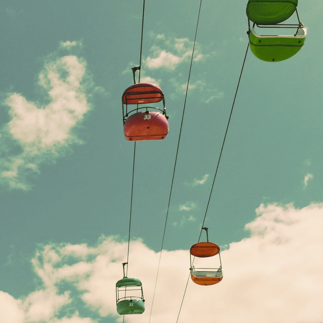 Looking into the sky with an overhead gondola beach boardwalk ride