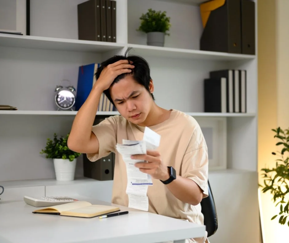 A man stressed about high utility bill.