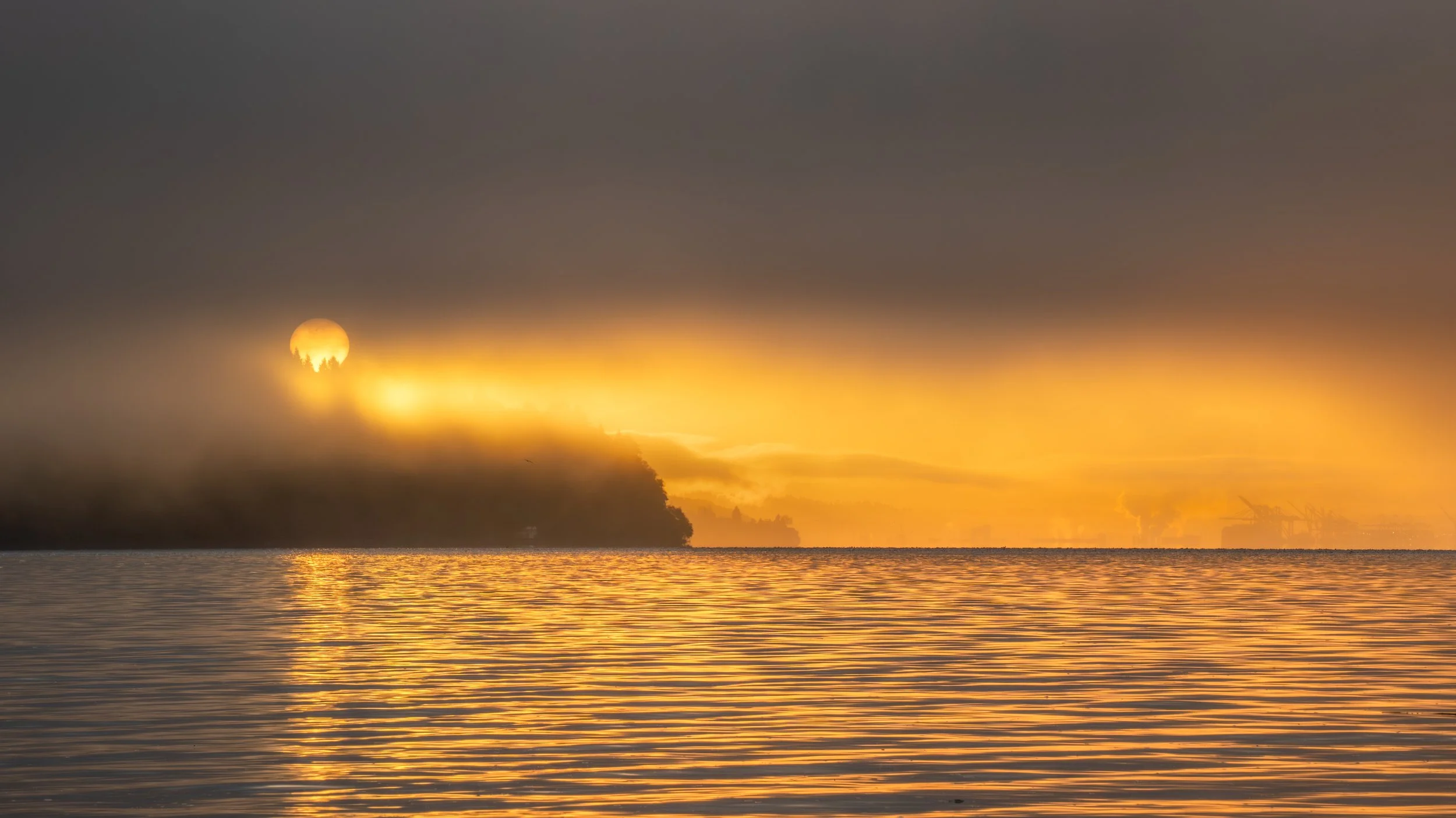 Breathtaking sunrise over Vashon Island with the Port of Tacoma in the fog. Some moments in photography are just special that way. 