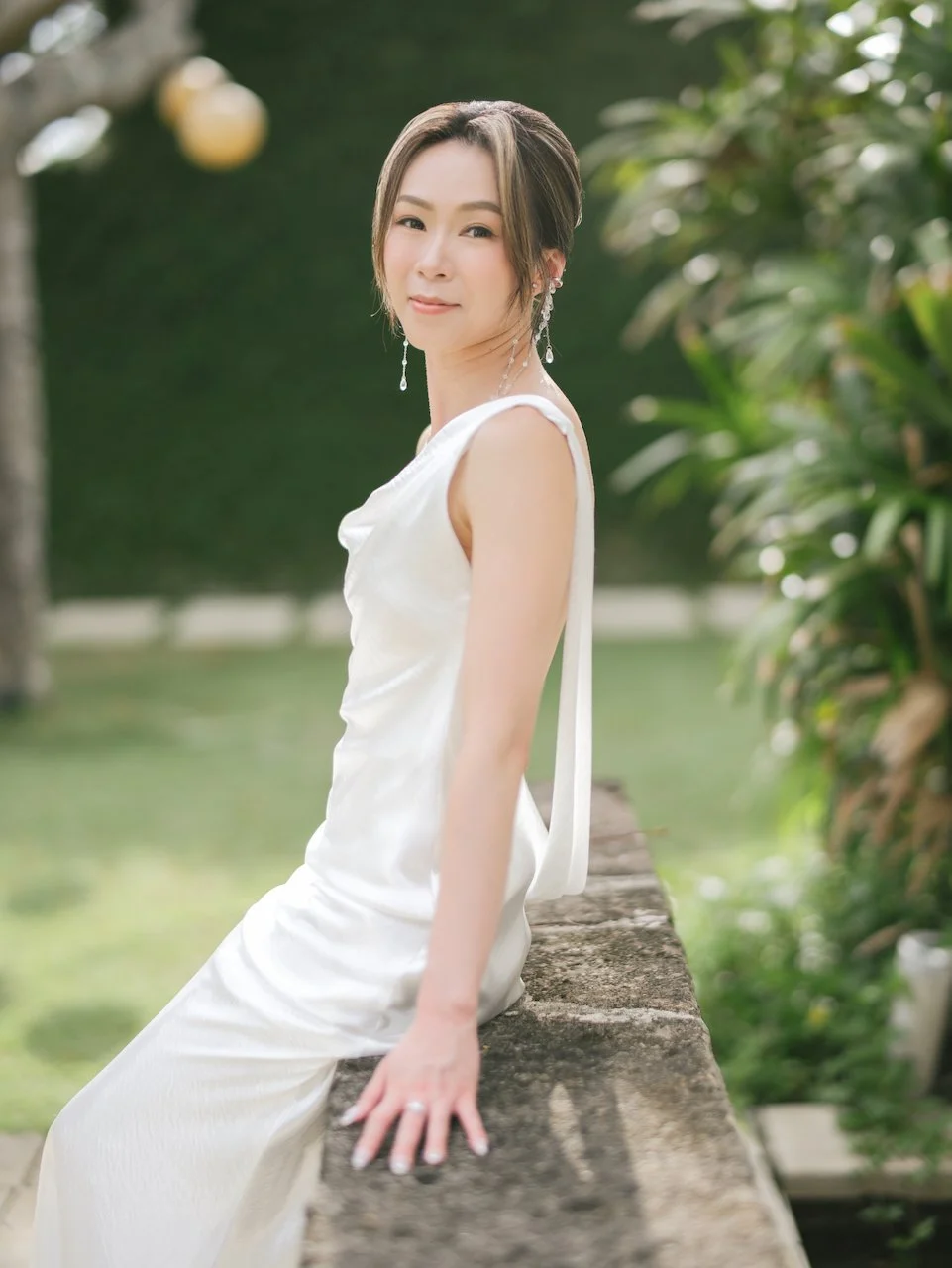 Bride portrait in a natural garden setting wearing a minimalist gown at an elegant Bali destination wedding.