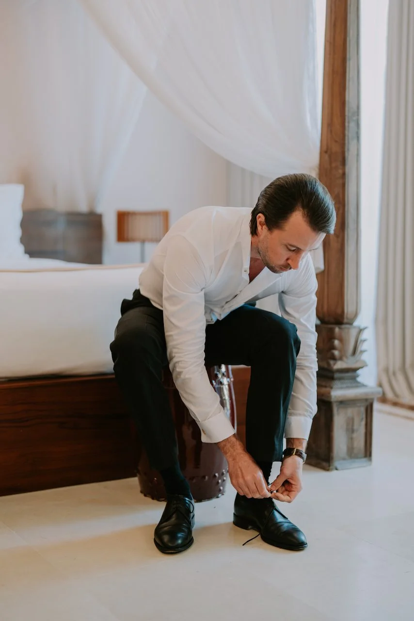 Groom getting ready in a private villa suite before his destination wedding at The Surga Bali