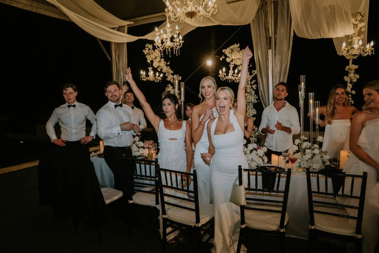 Wedding guests cheering during the evening reception at Sophia and Hamish’s destination wedding in Bali