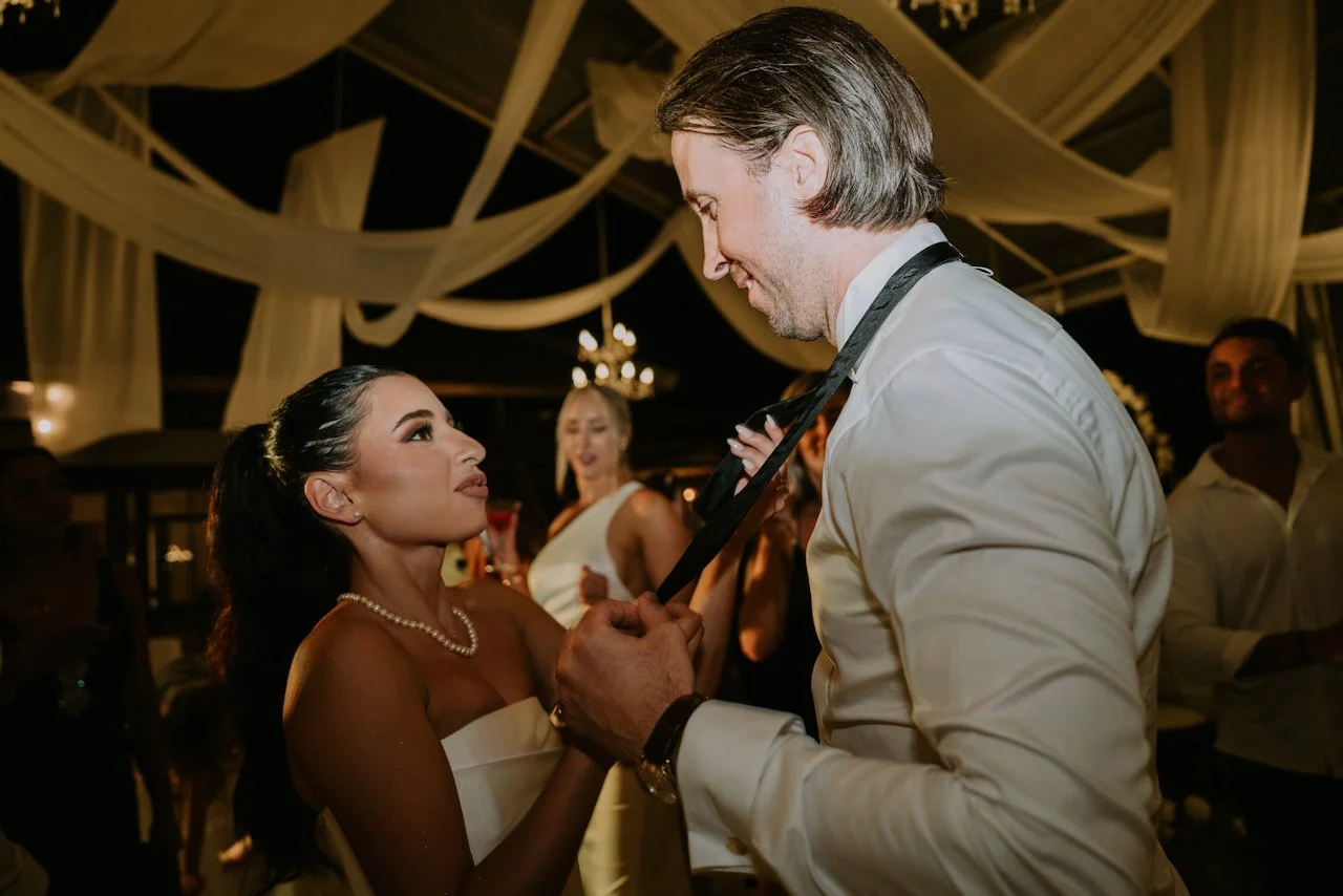 Bride and groom sharing an intimate dance moment during their candlelit evening wedding reception
