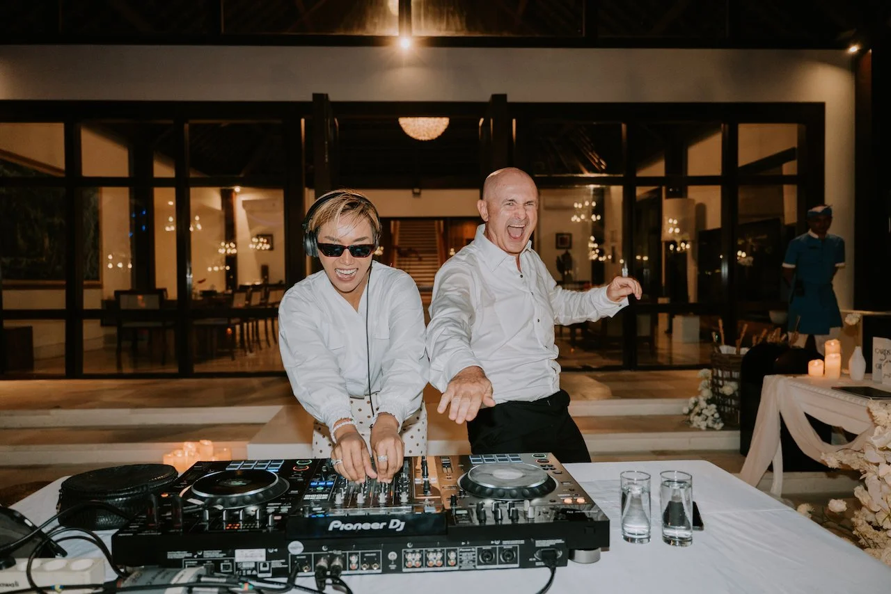 Wedding DJ and guests bringing energy to the dance floor during the evening reception at a Bali destination wedding