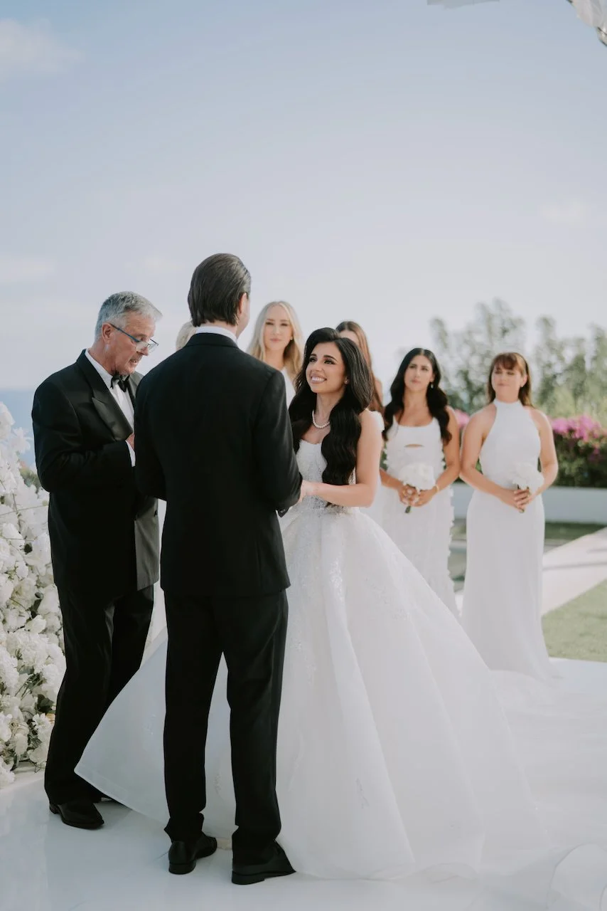 Bride smiling during the exchange of vows at her ocean-view wedding ceremony in Bali