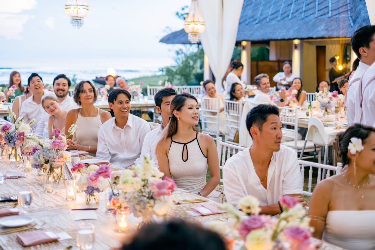 Wedding guests enjoying an oceanfront dinner reception planned by Silver Lace Weddings