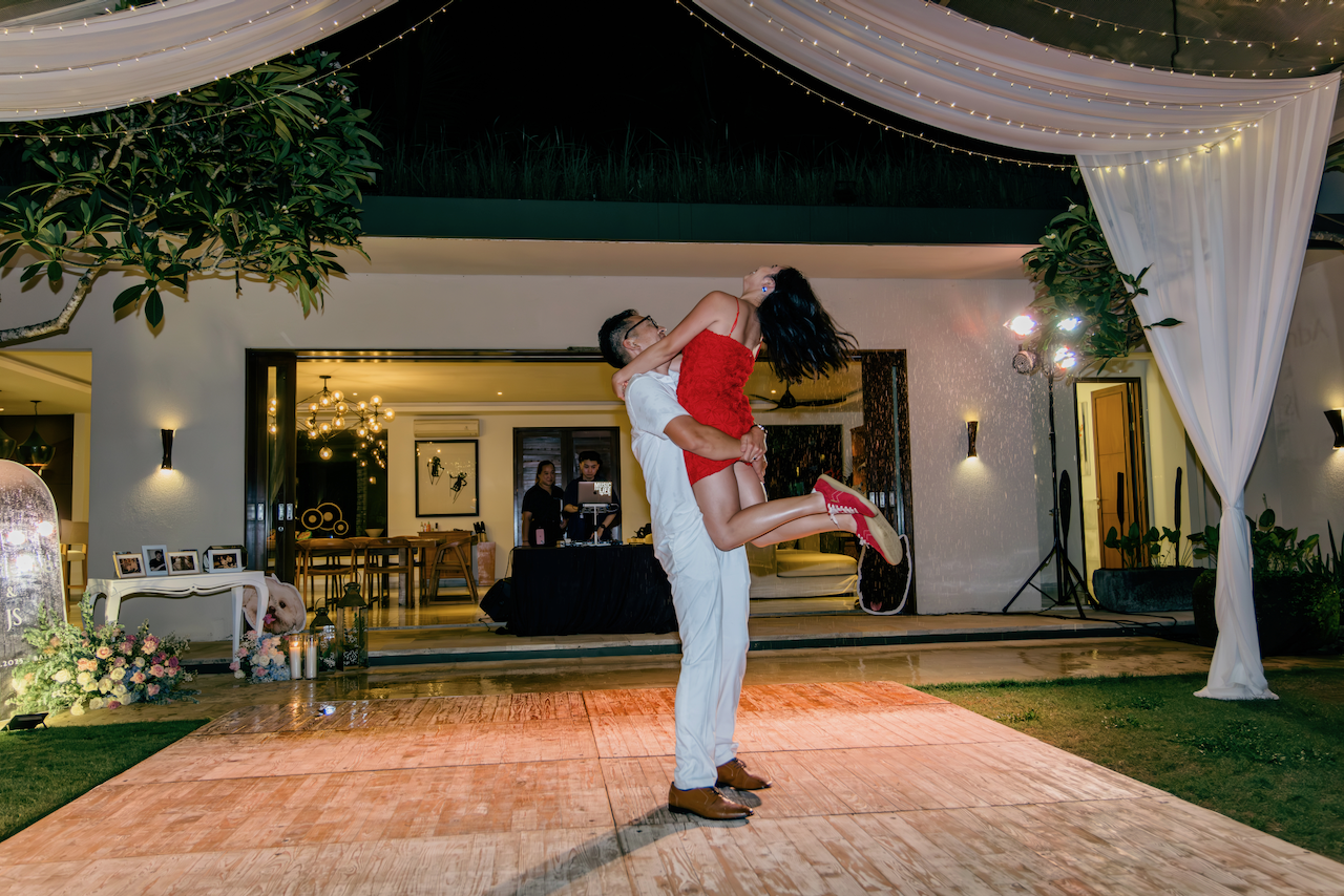 Groom lifting the bride during their first dance at a luxury Silver Lace Weddings event
