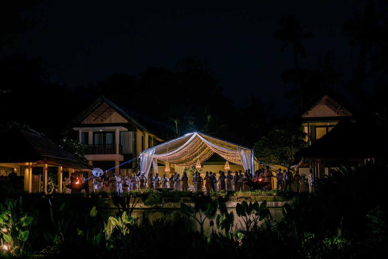 Illuminated marquee tent on the lawn of a stunning private villa for an evening wedding celebration in Bali