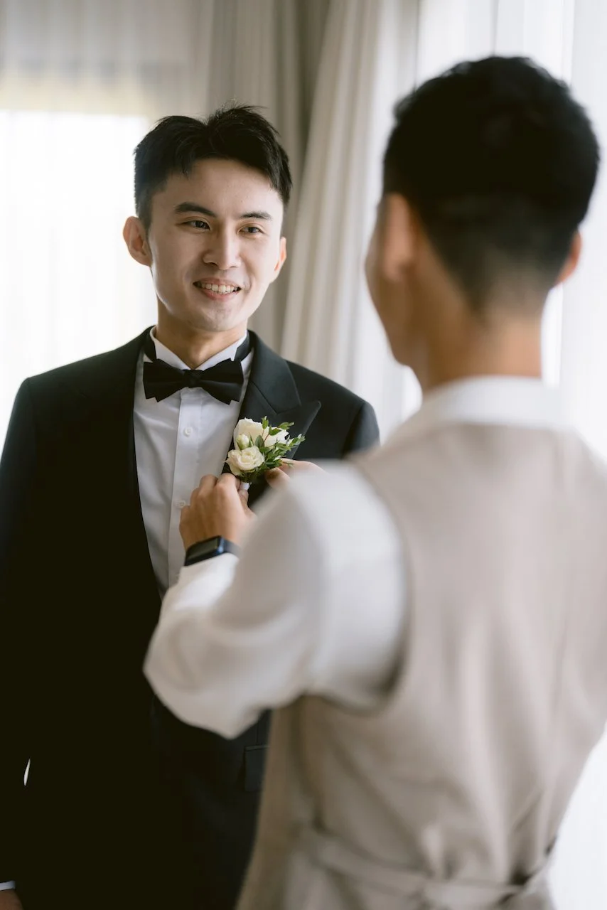 Groom getting ready with boutonniere at Surga Estate Bali wedding