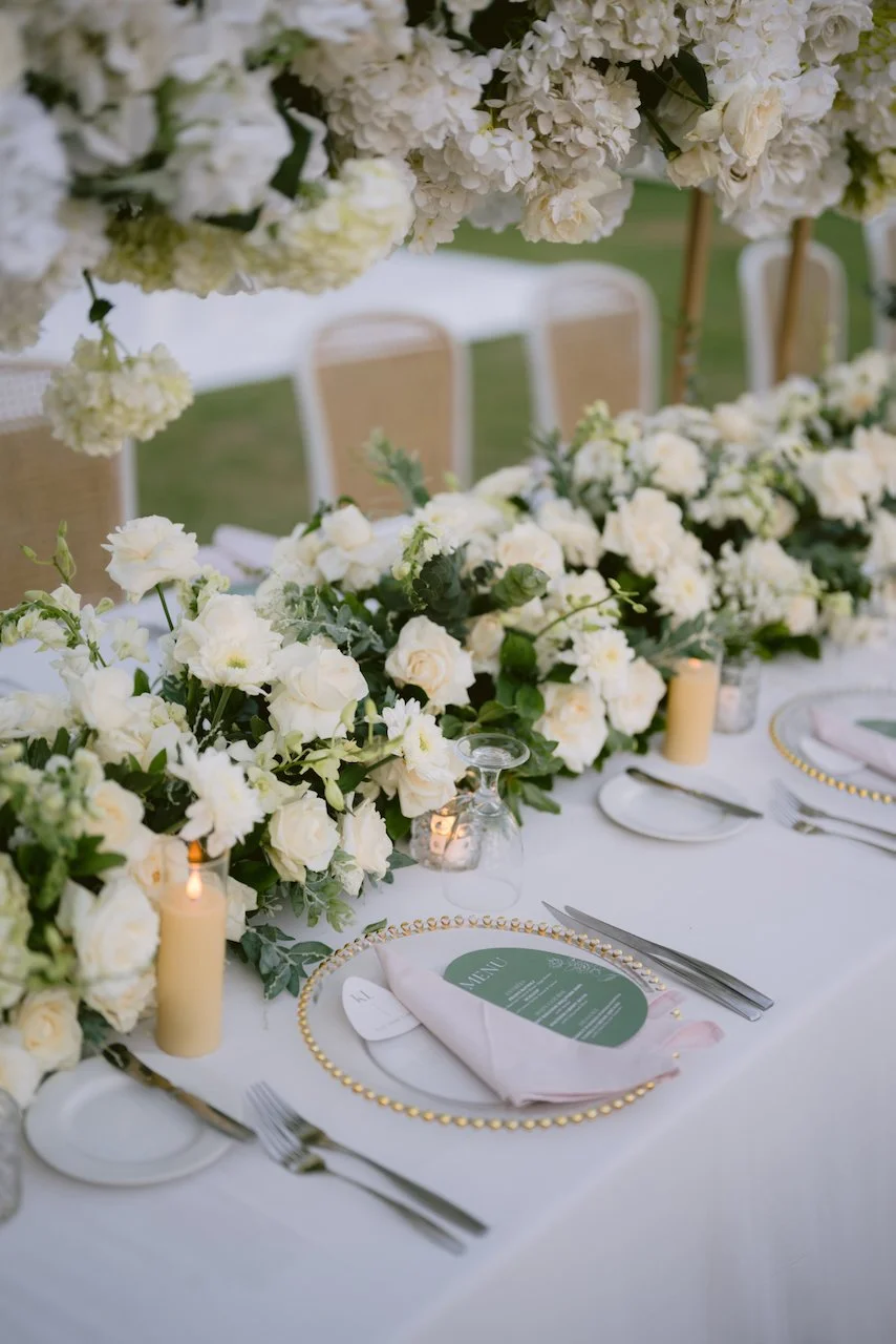 Elegant wedding table setting with greenery and candles at Bali villa reception