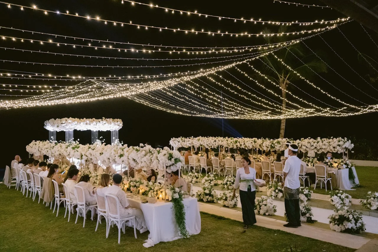 Outdoor wedding dinner under fairy lights at Surga Estate Bali