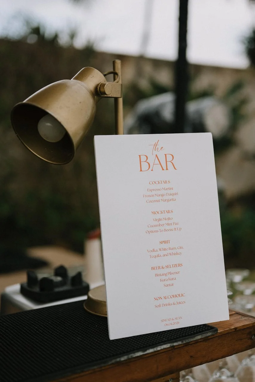 Modern custom bar menu sign featuring signature cocktails at an outdoor Seminyak reception.