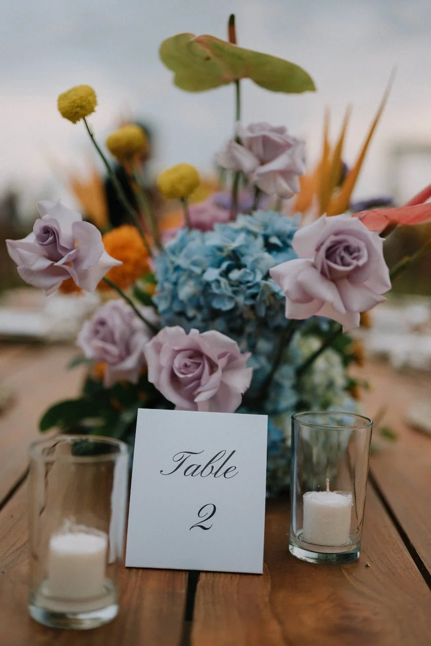 Elegant reception table number card paired with pastel roses and blue hydrangeas at Villa Phalosa.