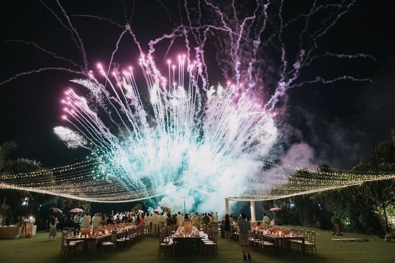 Spectacular nighttime fireworks display illuminating the outdoor fairy-light reception at Villa Phalosa Bali.