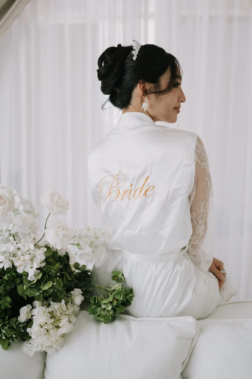 Bride wearing a custom gold-embroidered robe getting ready for her Uluwatu wedding.