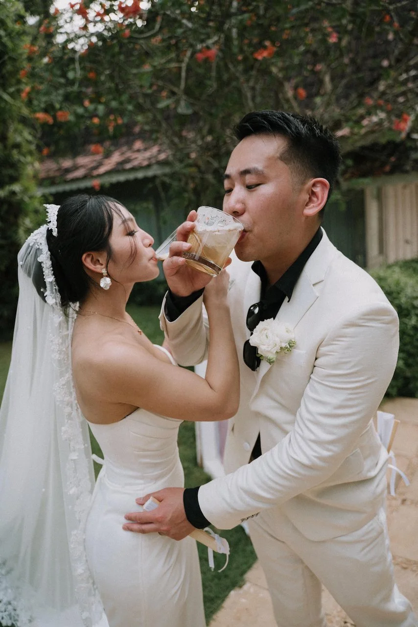 Newlyweds enjoying a celebratory drink together during their outdoor Bali cocktail hour.