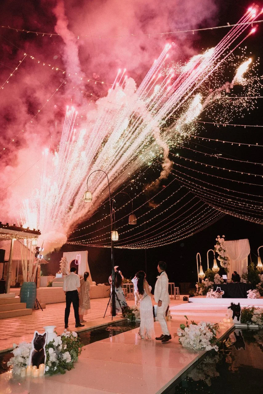 Spectacular nighttime wedding fireworks display over the outdoor reception at Villa Plenilunio Bali.