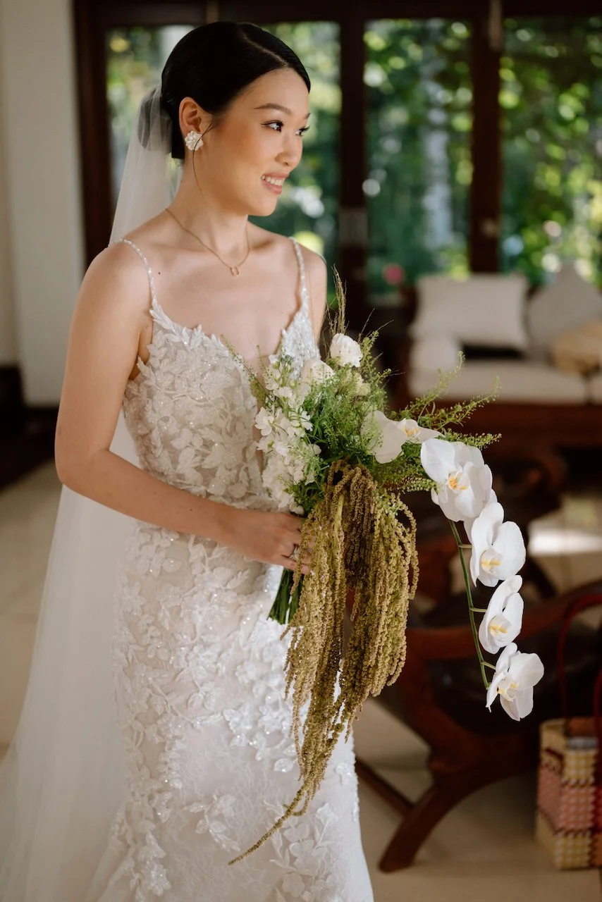 Smiling bride making her grand entrance down the aisle at Villa Pemutih.