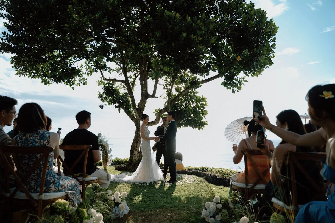 Couple exchanging vows by the ocean at a Bali destination wedding.