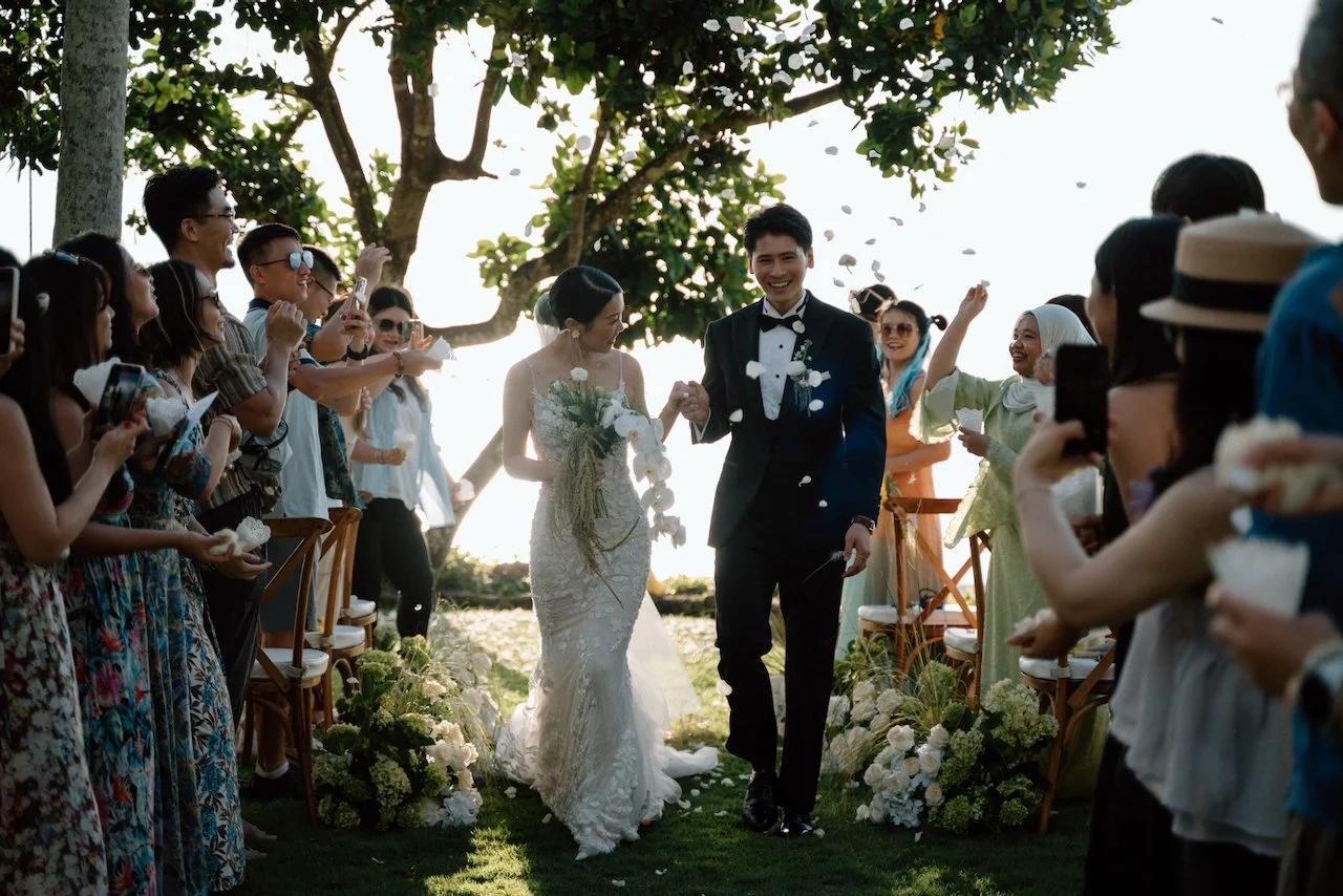 Newlyweds celebrating through a confetti toss planned by Silver Lace Weddings.