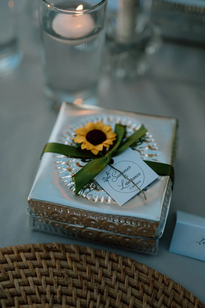 Close-up of a square wedding favor box designed by Silver Lace Weddings.